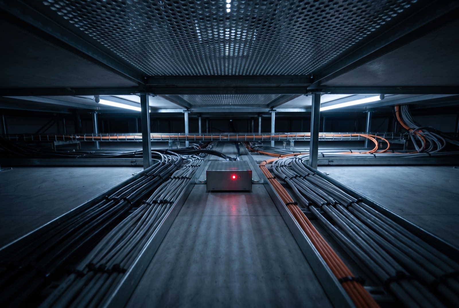 Sub-floor plenum beneath a raised data-centre floor, the primary contamination risk zone